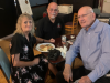 FLVCS members Camille, Hector, and Jim sitting at a table at the 2022 Tom Paine Party.