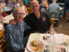 FLVCS Member, Geoffrey, with guest, Joel, sitting at a table at the 2022 Tom Paine Party.