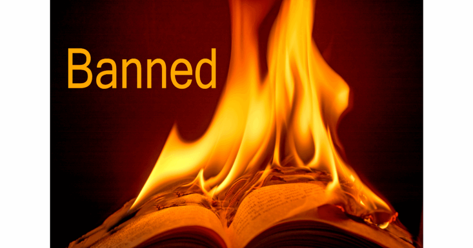 Burning book with the word Banned on a black background and close up with brilliant flames.