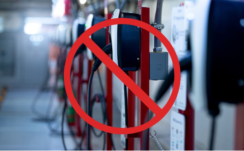 Red circle with slash on bank of EV chargers denoting DeSantis holding on to EV charger millions.