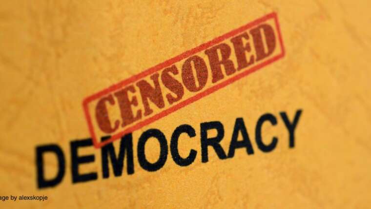 Censored - Democracy text on an orange background